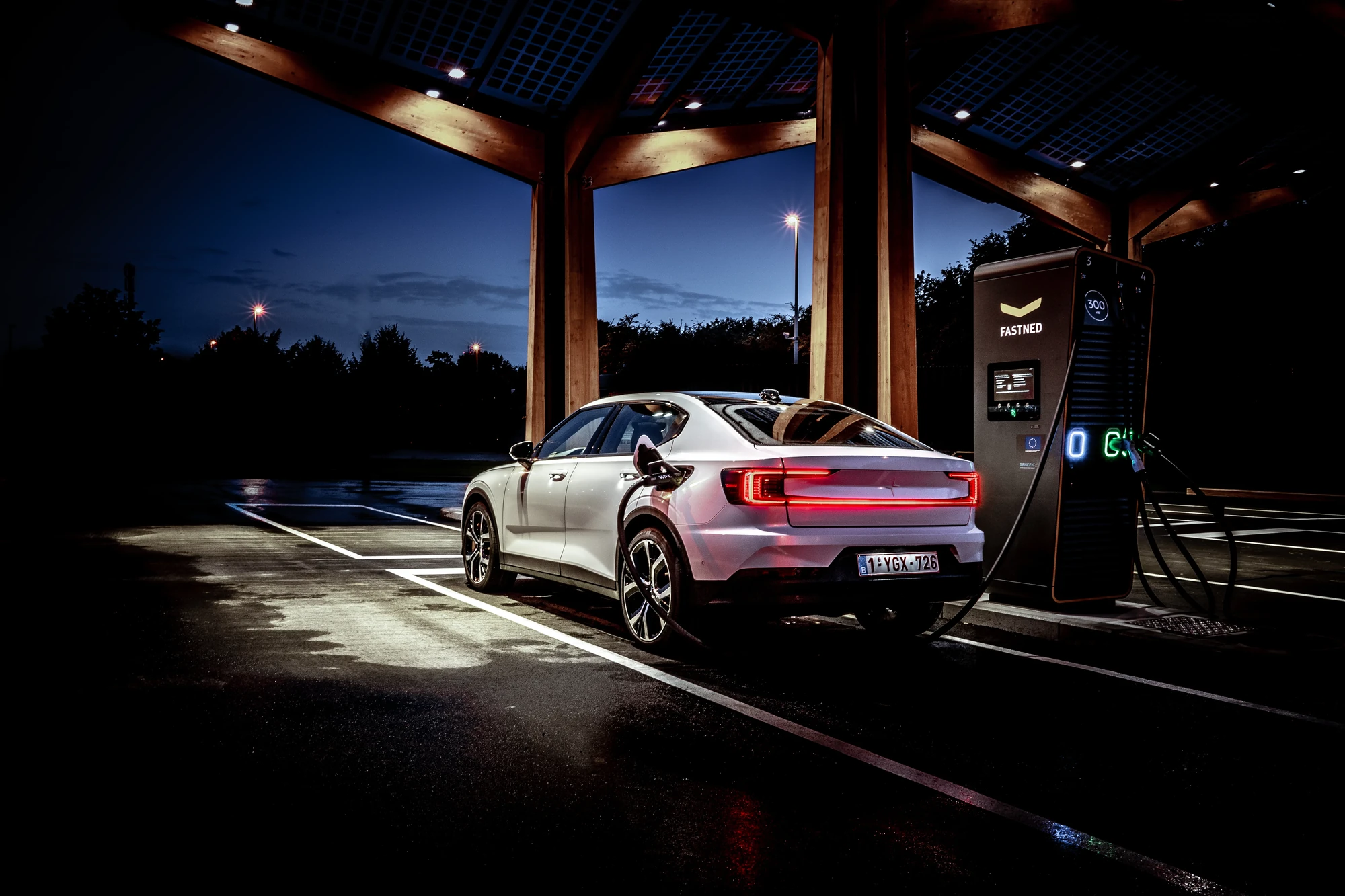 EV charging infrastructure under canopy at dusk